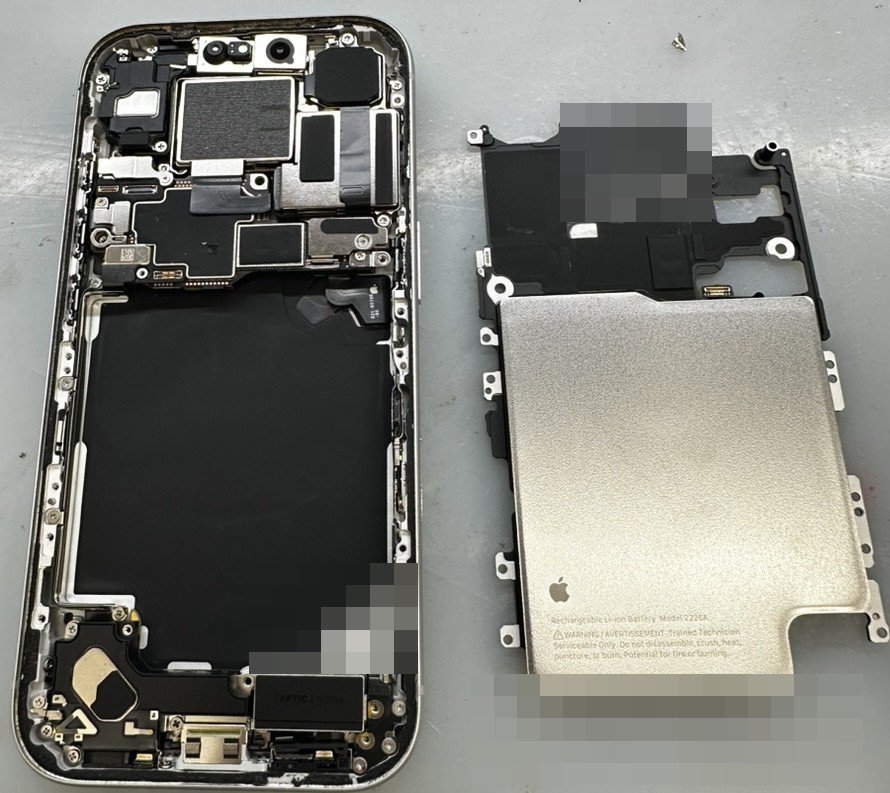 iPhone 17 Proの内部。基板修理のため取り外したバッテリーとシールドプレート