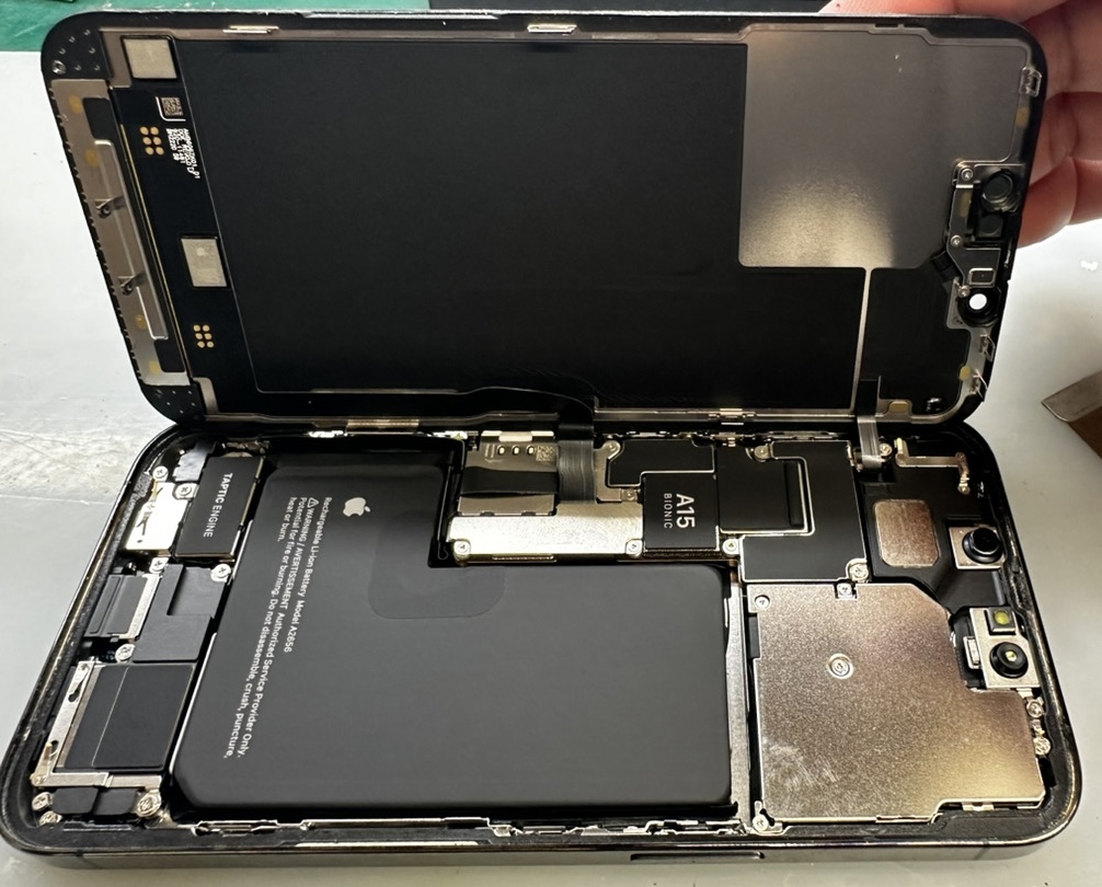 iPhone 13 Proを開き、ディスプレイを外して基板側を確認している作業中の様子